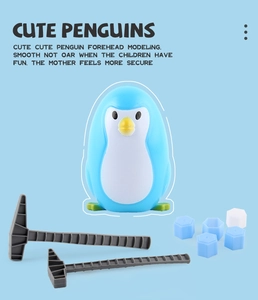 Close-up of penguin ice breaking game pieces including blue penguin and plastic hammers
