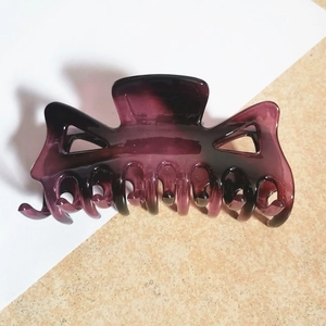 Detailed top view of a large translucent deep purple hollow geometric hair claw clip
