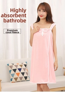 Detail of pink coral fleece bath towel dress featuring a decorative bow and white piping