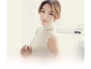 Detailed texture of beige sleeveless high-neck knit top on a model in soft sunlight