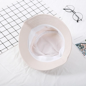 Classic beige bucket hat with breathable white mesh lining and minimalist design