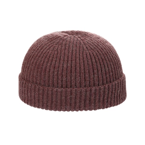 Deep red knitted skull cap with thick ribbed texture and wide folded brim for winter style