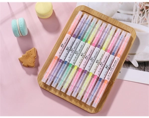 Detailed close-up of 12 colorful double-ended highlighters arranged on a bamboo tray