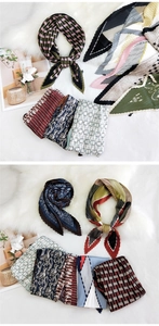 Detail of pleated satin square scarves with diverse patterns on white plush background