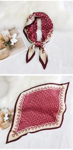 Macro detail of pleated burgundy silk scarf with geometric pattern on plush carpet