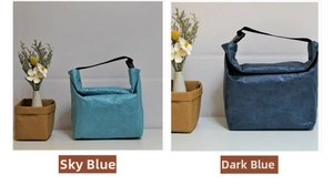 Detail view of Tyvek paper lunch bags in sky blue and navy blue with buckle closures