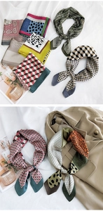 Macro view of multi-pattern silk square scarves paired with a classic khaki trench coat
