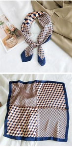 Detail of silk scarf with navy and orange geometric print styled on a trench coat
