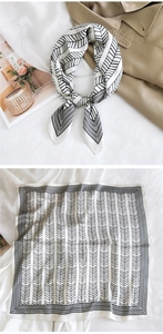 Detail of silk square scarf with black and white geometric patterns and satin texture