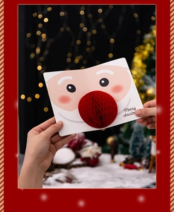 Detail of 3D Santa card with red honeycomb paper nose and festive Merry Christmas text