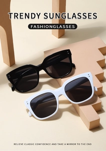 Macro detail of retro square sunglasses featuring wide frames and metallic dot accents
