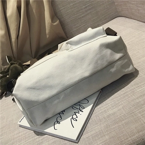 Close-up of white canvas tote bag showing durable fabric texture in a home setting