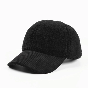 Detail of black baseball cap showing sherpa crown and corduroy brim texture contrast
