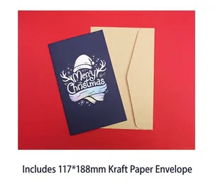 Detail of blue Merry Christmas card with rainbow foil text and kraft paper envelope