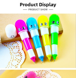Close-up of four colorful pill-shaped retractable ballpoint pens with cute face expressions