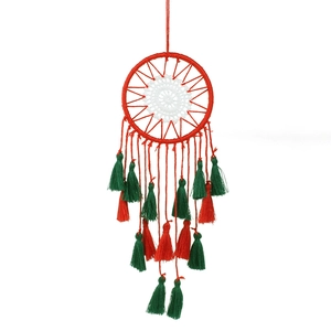 Handmade Christmas dreamcatcher with red and green tassels for wall decoration
