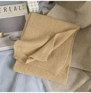 Detailed view of ginger yellow ribbed knit scarf texture with thick warm fabric