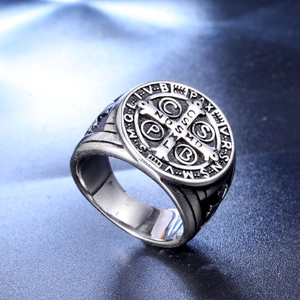 Macro view of vintage stainless steel St. Benedict cross ring with engraved details