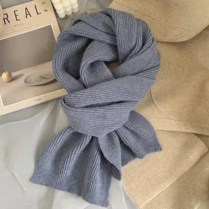 Soft chunky knit scarf in dusty blue color with classic ribbed texture for winter warmth