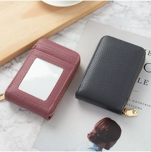 Litchi texture leather mini zip card holders in dusty rose and black on marble surface