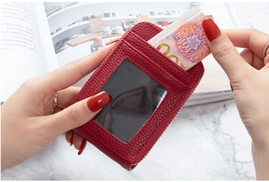 Detail of red litchi texture card holder with zipper closure and transparent photo slot