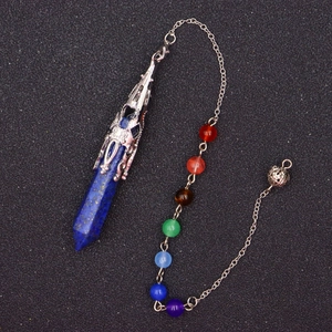 Macro detail of Lapis Lazuli hexagonal crystal point with seven chakra beads and metal chain