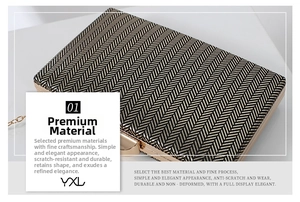 Detail of elegant black and gold herringbone texture on clutch bag with chain strap