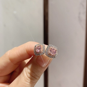 Macro shot of square pink zircon stud earrings with double diamond halo in rose gold plating
