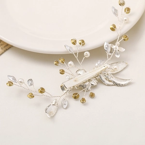 Macro detail of leaf hair clip with pearls and rhinestones on a silver alligator clip