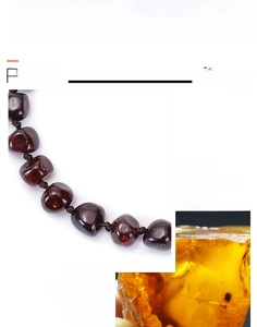 Macro detail of handmade Baltic amber beads in deep red blood amber for baby bracelets