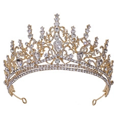 Detailed close-up of Baroque gold crown with sparkling rhinestones and leaf motifs