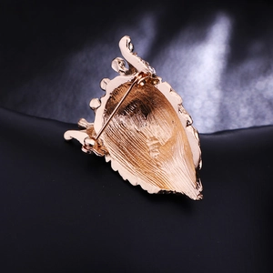Golden lion king brooch back view showing brushed metal texture and secure safety pin fastener