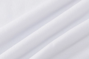 Close-up of white ribbed knit fabric texture showing high-quality stitching and softness