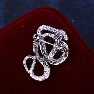 Close-up of snake brooch back with vintage silver scales and secure safety pin clasp