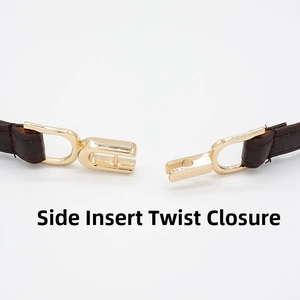 Detail of the side-insert twist closure buckle on a slim dark brown leather belt