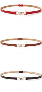 Three thin leather belts in red, camel, and coffee colors with golden buckles for dresses