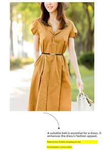 Close-up of a slim black leather belt with metal buckle on a ginger yellow dress
