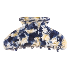 Detailed view of large marble pattern hair claw clip with sturdy blue teeth on white background