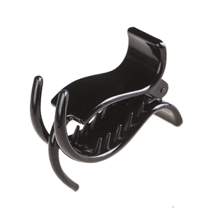 Classic glossy black plastic hair claw clip for elegant bun hairstyles on white background