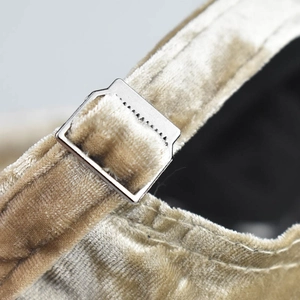 Macro detail of champagne chenille baseball cap featuring a premium metal adjustable buckle