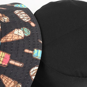 Detail of reversible bucket hat with colorful ice cream print and black cotton texture