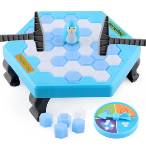 Children's penguin trap board game set with blue ice blocks and two hammers on white background