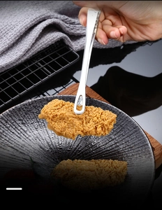 Close-up of 304 stainless steel BBQ tongs with hollow design for fried chicken