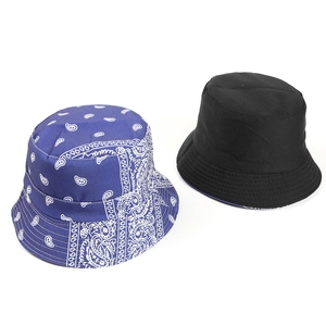 Reversible paisley print bucket hat in navy blue and plain black cotton twill fabric