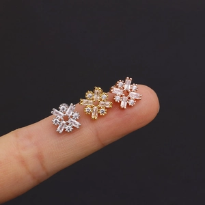 Three flower-shaped stainless steel stud earrings with zircon crystals in silver, gold and rose gold