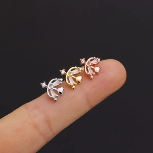 Detailed view of heart and arrow screw back earrings in silver, gold, and rose gold finishes