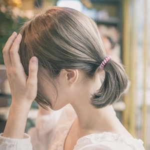 Pink elastic hair tie for girls with high-stretch fiber shown in a ponytail ponytail view