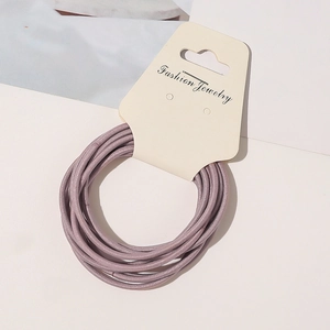 Close-up of high-elastic purple thin hair ties set on a beige display card