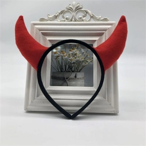 Detailed front view of red devil horns headband with soft plush texture for parties