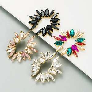 Detail of vintage sunflower earrings with turquoise and rhinestones on gold base